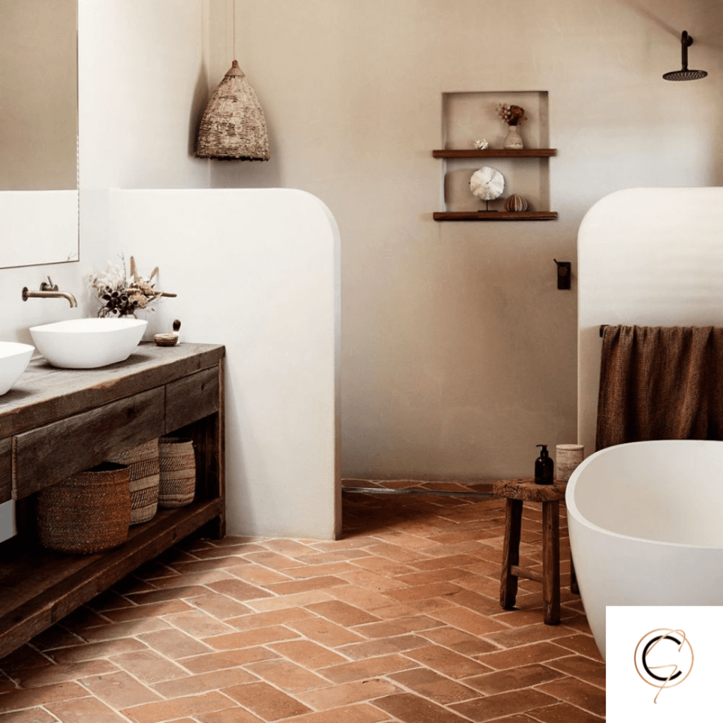 Rustic handmade terracotta floor tile in warm golden-red tones with natural surface variation