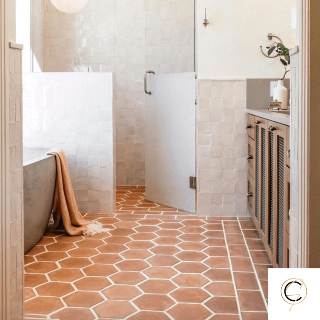 Rustic handmade terracotta floor tile in warm golden-red tones with natural surface variation