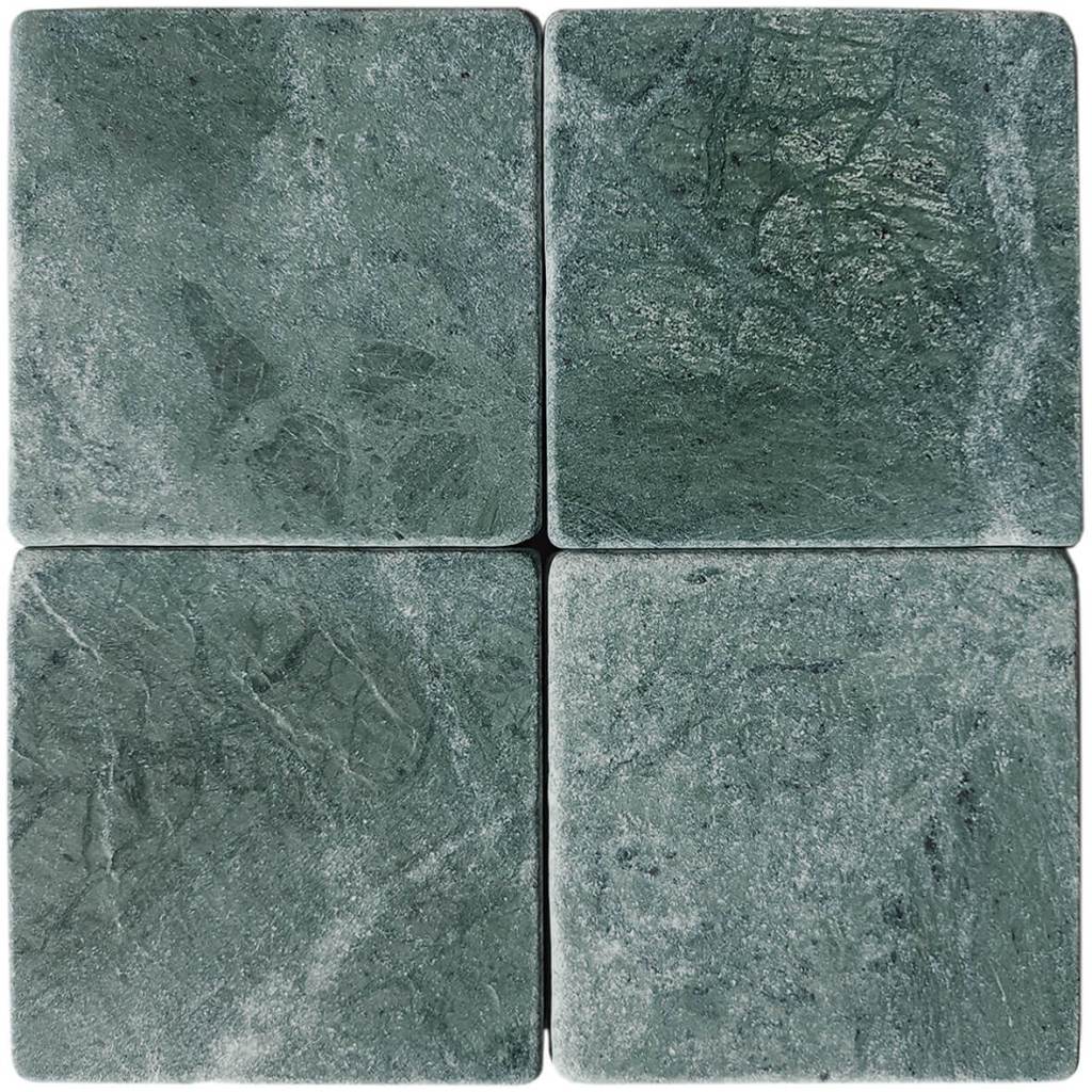 Tumbled square natural stone tiles in mixed neutral tones, laid in a soft grid across an outdoor floor. Visible variation and softened edges.