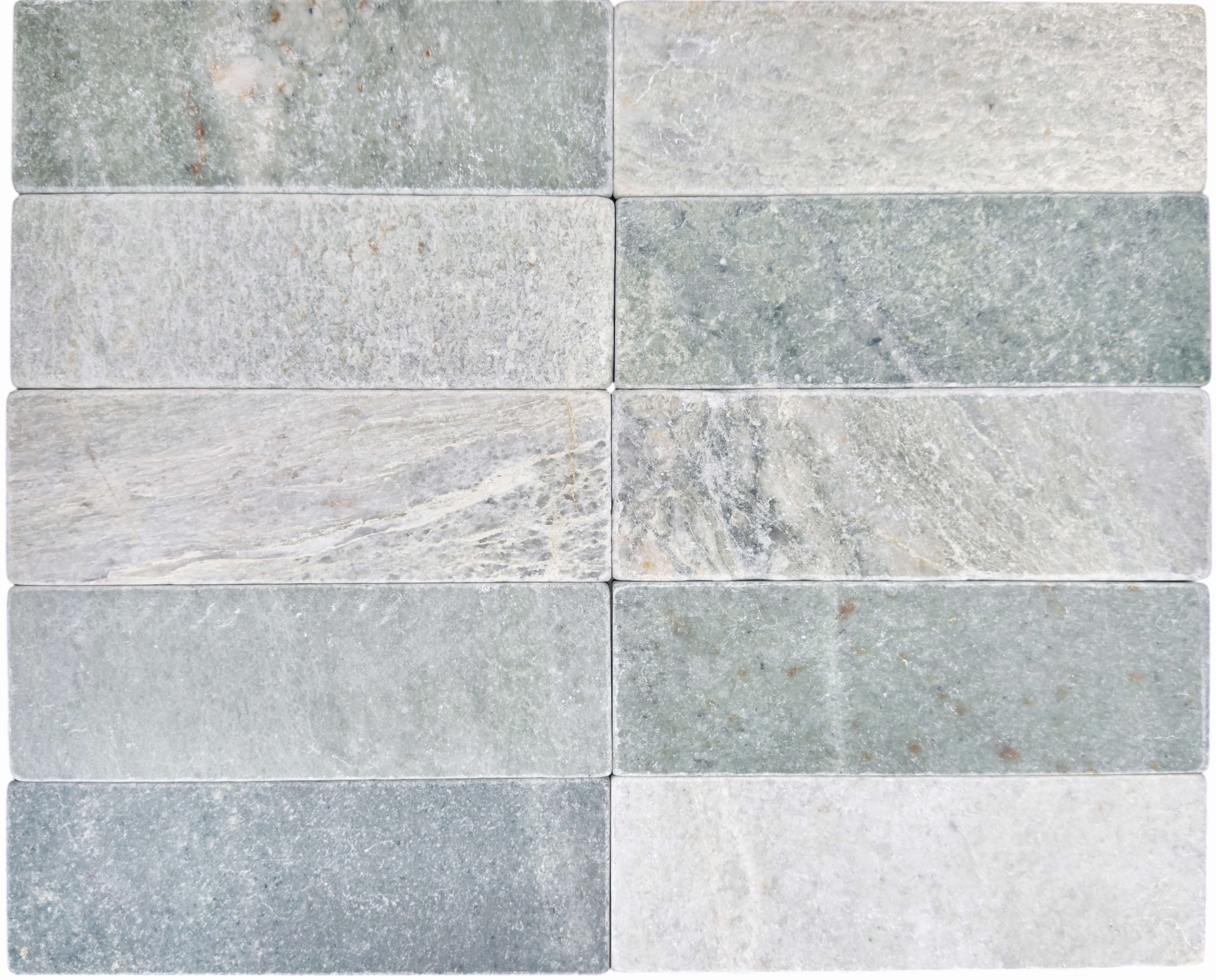 Slim tumbled natural stone batons laid in a soft neutral herringbone pattern, showing subtle surface variation and texture, suitable for indoor or outdoor use.