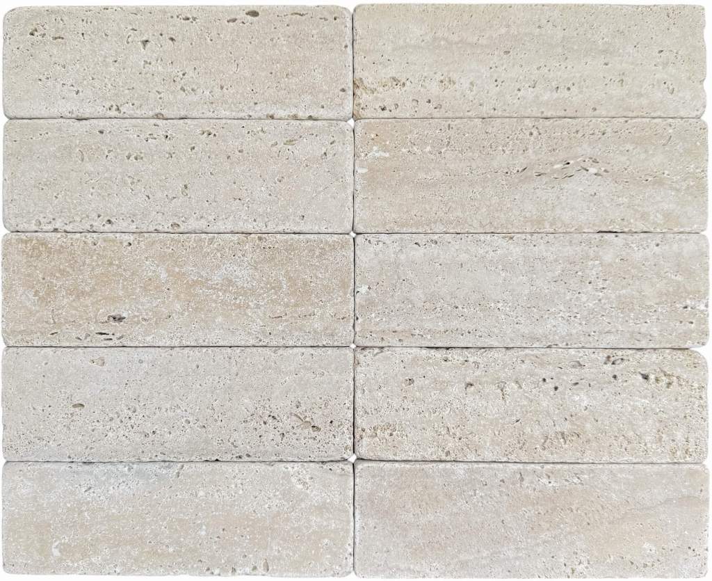 Slim tumbled natural stone batons laid in a soft neutral herringbone pattern, showing subtle surface variation and texture, suitable for indoor or outdoor use.