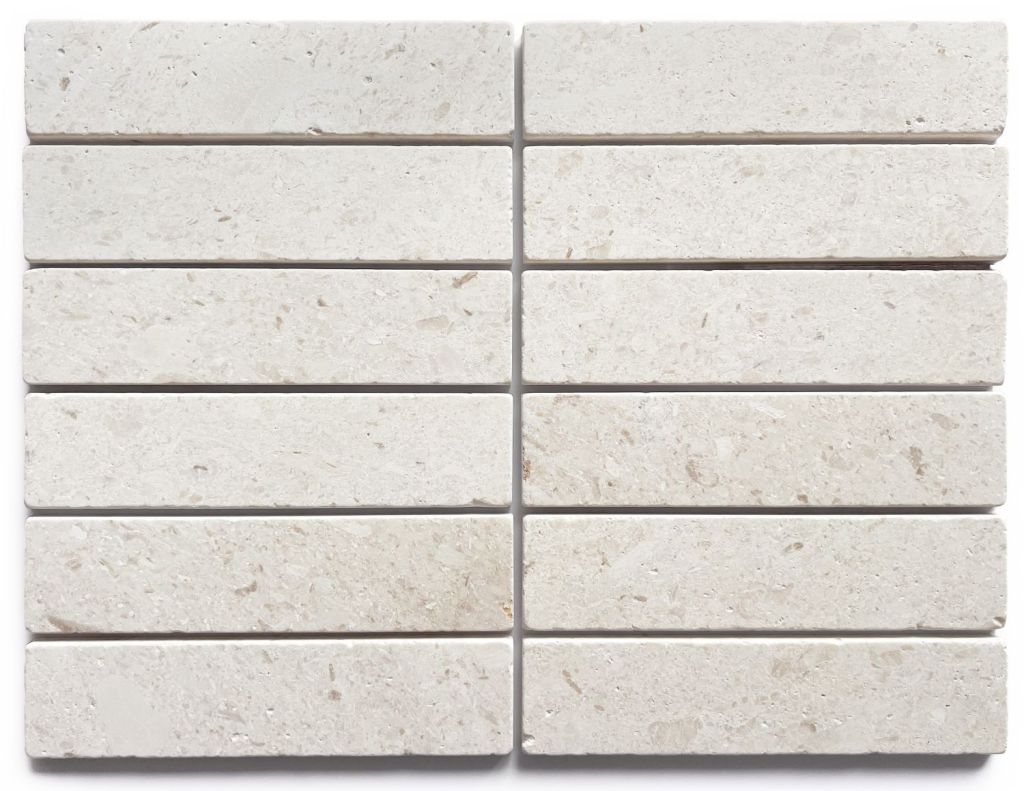 Slim tumbled natural stone batons laid in a soft neutral herringbone pattern, showing subtle surface variation and texture, suitable for indoor or outdoor use.