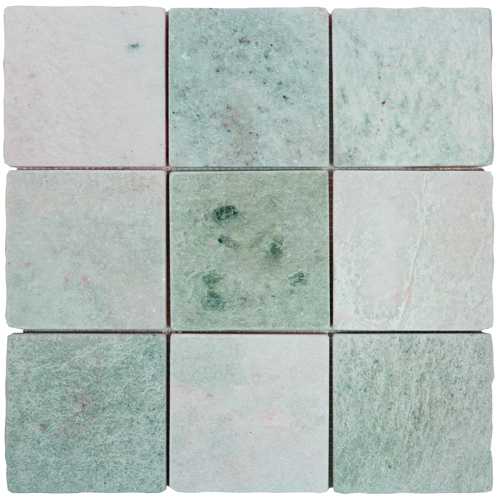 Tumbled square natural stone tiles in mixed neutral tones, laid in a soft grid across an outdoor floor. Visible variation and softened edges.