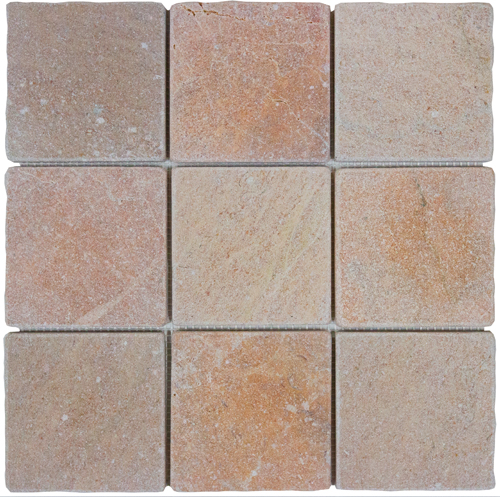 Tumbled square natural stone tiles in mixed neutral tones, laid in a soft grid across an outdoor floor. Visible variation and softened edges.