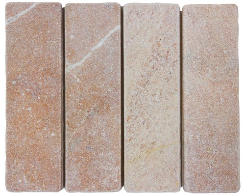Slim tumbled natural stone batons laid in a soft neutral herringbone pattern, showing subtle surface variation and texture, suitable for indoor or outdoor use.